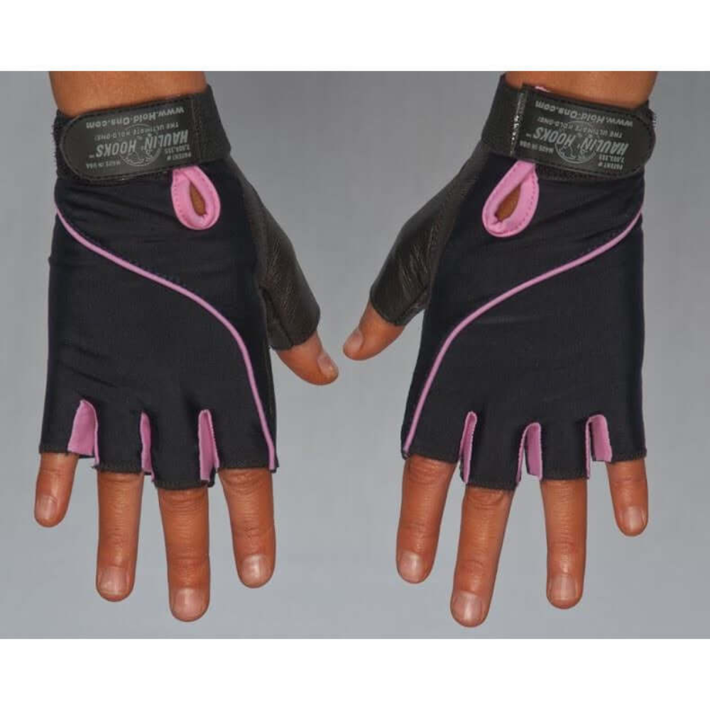 Someone wearing HAULIN HOOKS GLOVES 'Womens' in black and pink with padded protection against a gray background.
