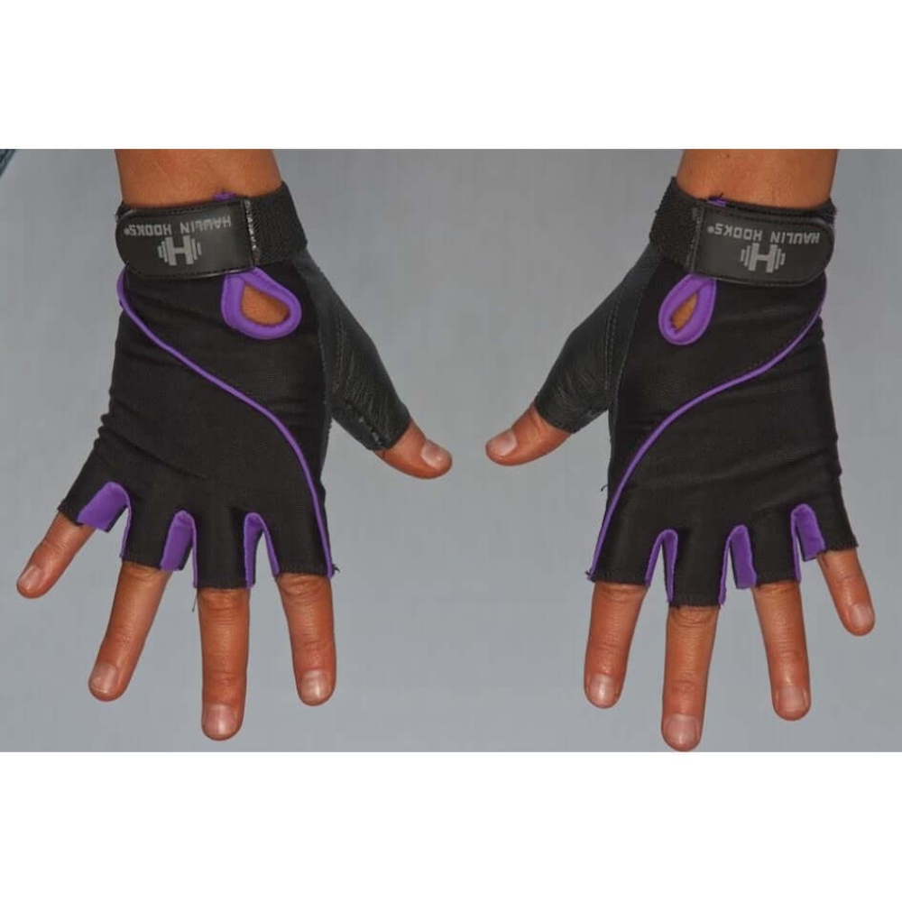 Two hands sport black and purple fingerless HAULIN HOOKS GLOVES 'Womens' with "Harbinger" branding on the wrists, providing padded protection for better grip. They're machine washable, making them ideal for fitness enthusiasts.
