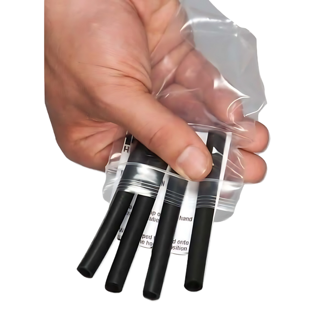 A hand holds four HAULIN HOOKS 'ORIGINALS' Hooks for Weightlifting Extreme! in black plastic inside a clear resealable bag.