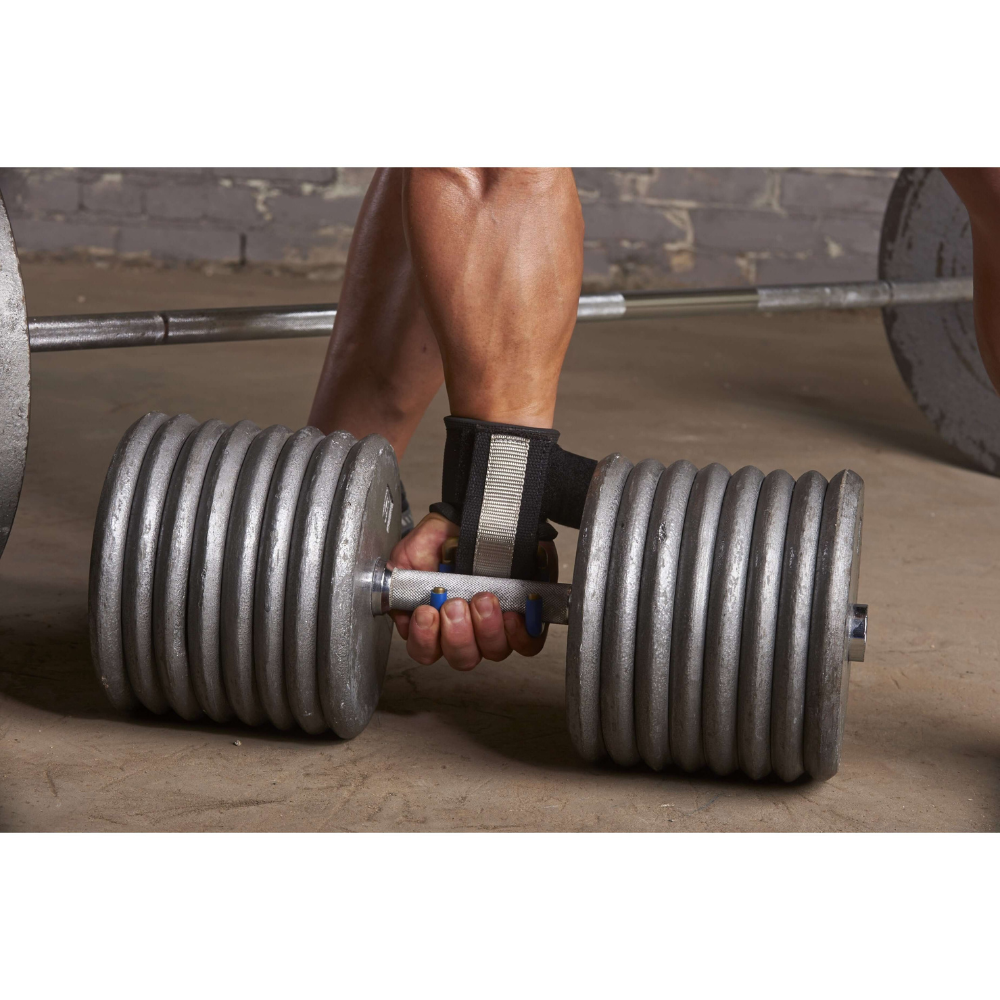 A person grips a large metal dumbbell with HAULIN HOOKS 'PROFESSIONAL' neoprene wrist protection, enhancing their hold on the gym floor and perfecting their deadlift form.