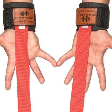 Hands are shown wearing black wrist straps with neoprene padding and red lifting straps, labeled "HAULIN HOOKS 'STRAP 650'," a top choice for those seeking durable, USA-made gym straps.
