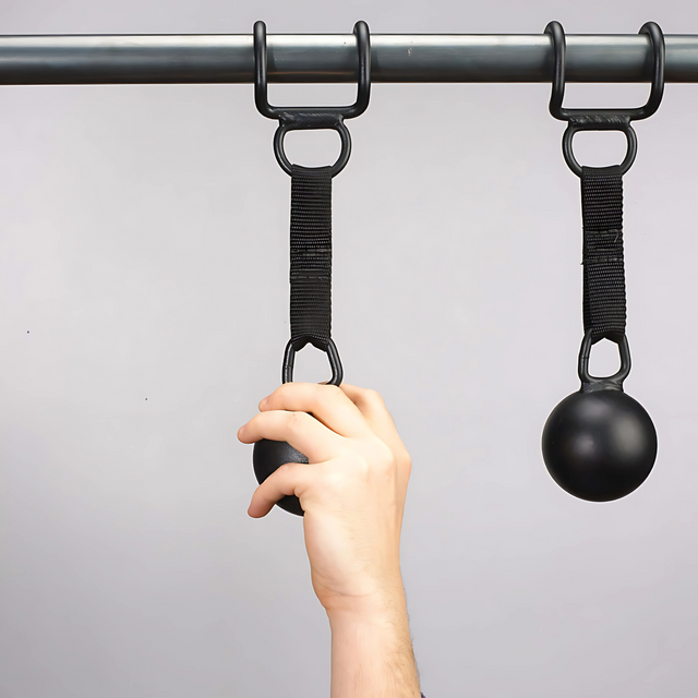 A hand grips a HOG LEGS 'Raging Boar' Pull-Up Grip, attached to a pull-up bar with a strap—perfect for enhancing grip strength during back workouts.