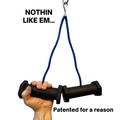 A hand grips two PULL FORCE GEN 2 Double Grips Cable Gym Attachments, connected by a blue resistance band and a metal clip.