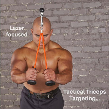 A muscular man exercises with TACTI-TRICEPS Double Long Head Tricep attachment gym handles against a brick wall, showcasing "Lazer focused" tricep targeting.