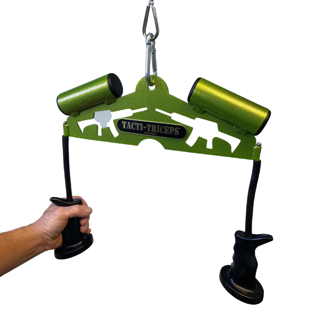 A hand holds the green TRICEPS TRIBULATION Cable Machine Attachment Set, featuring black handles and two green tubes—ideal for triceps workouts on cable gym machines.