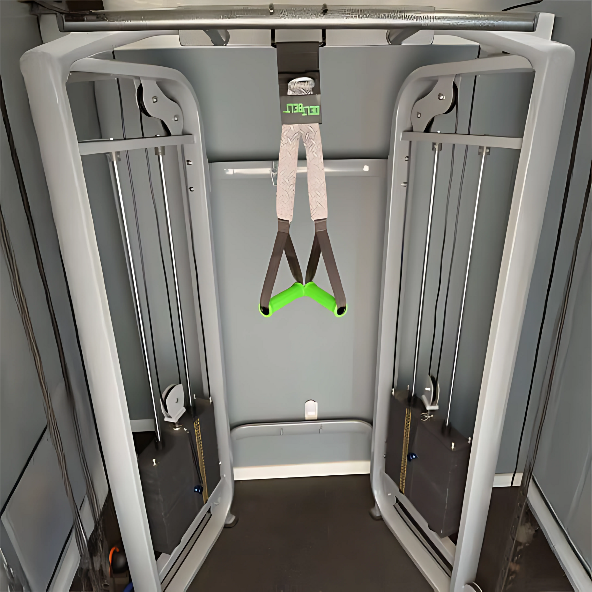 DELT-BELT Handle Straps for Cable Machine Upright Rows plus! with green handles and Multi-Exercise Handles hanging at the center of a gym cable crossover machine.