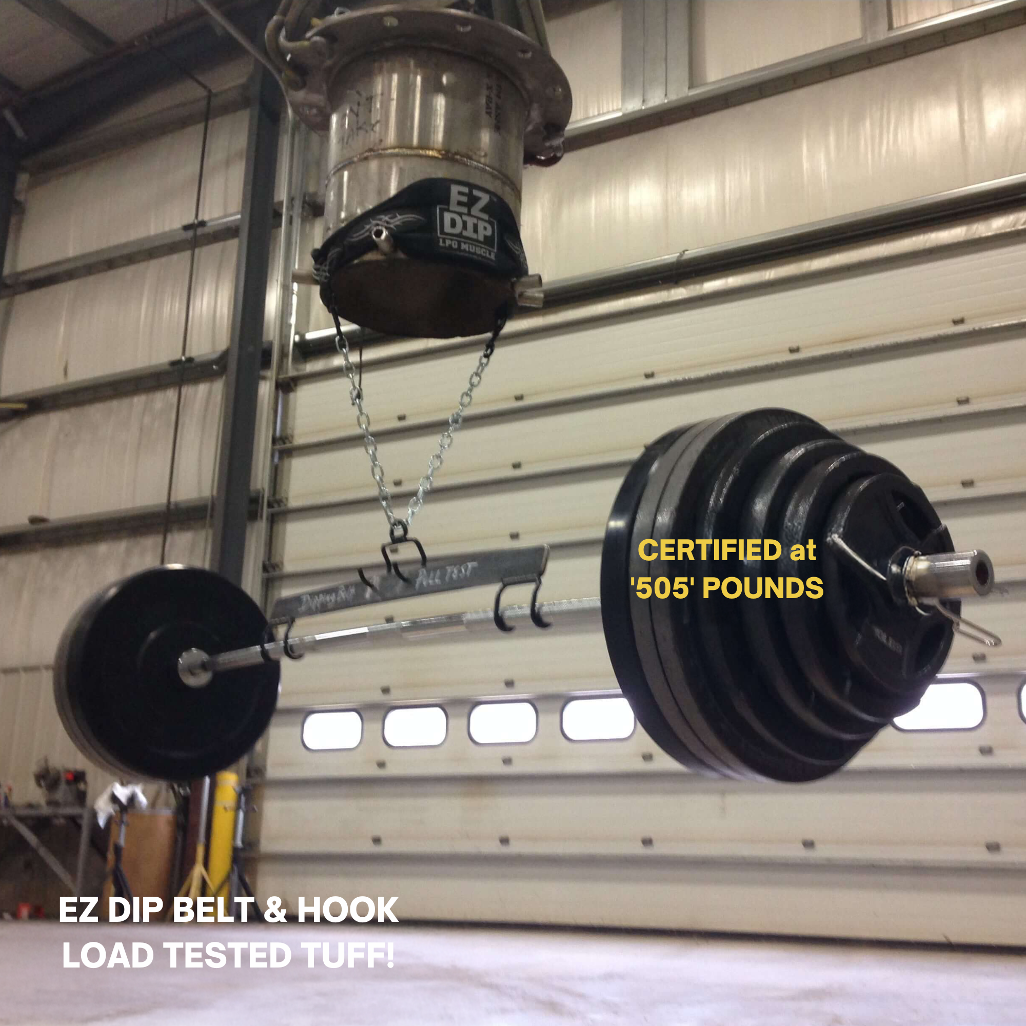 The E-Z DIP Belt with Chain, Dumbbell Hook, and Universal Plate Holder is shown in a large industrial garage, supporting weight plates for dynamic training sessions.