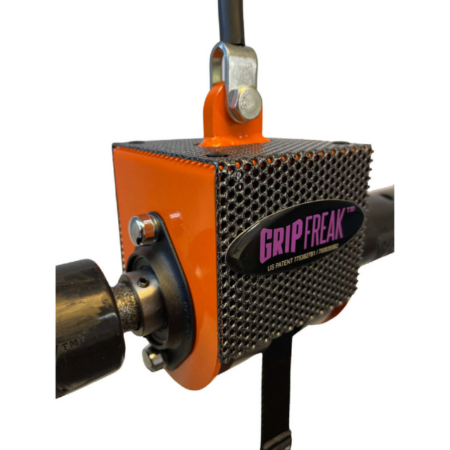 Close-up of the orange and black "GRIP FREAK Fat Grip WRIST ROLLER" forearm workout tool, featuring a textured surface designed for crushing grip torque.