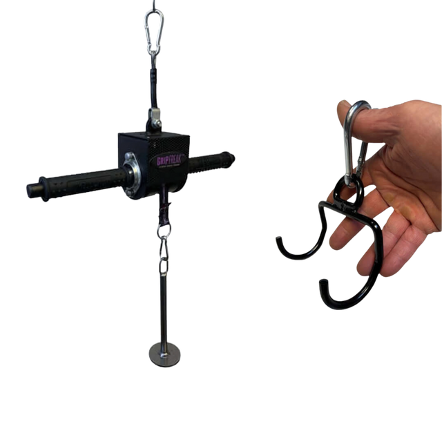 A hand grips the GRIP FREAK 'Slip Grip' Brutal Hand Grip Strengthener, a black tool with handles and metal attachments—perfect for grip targeting or an intense forearm workout.