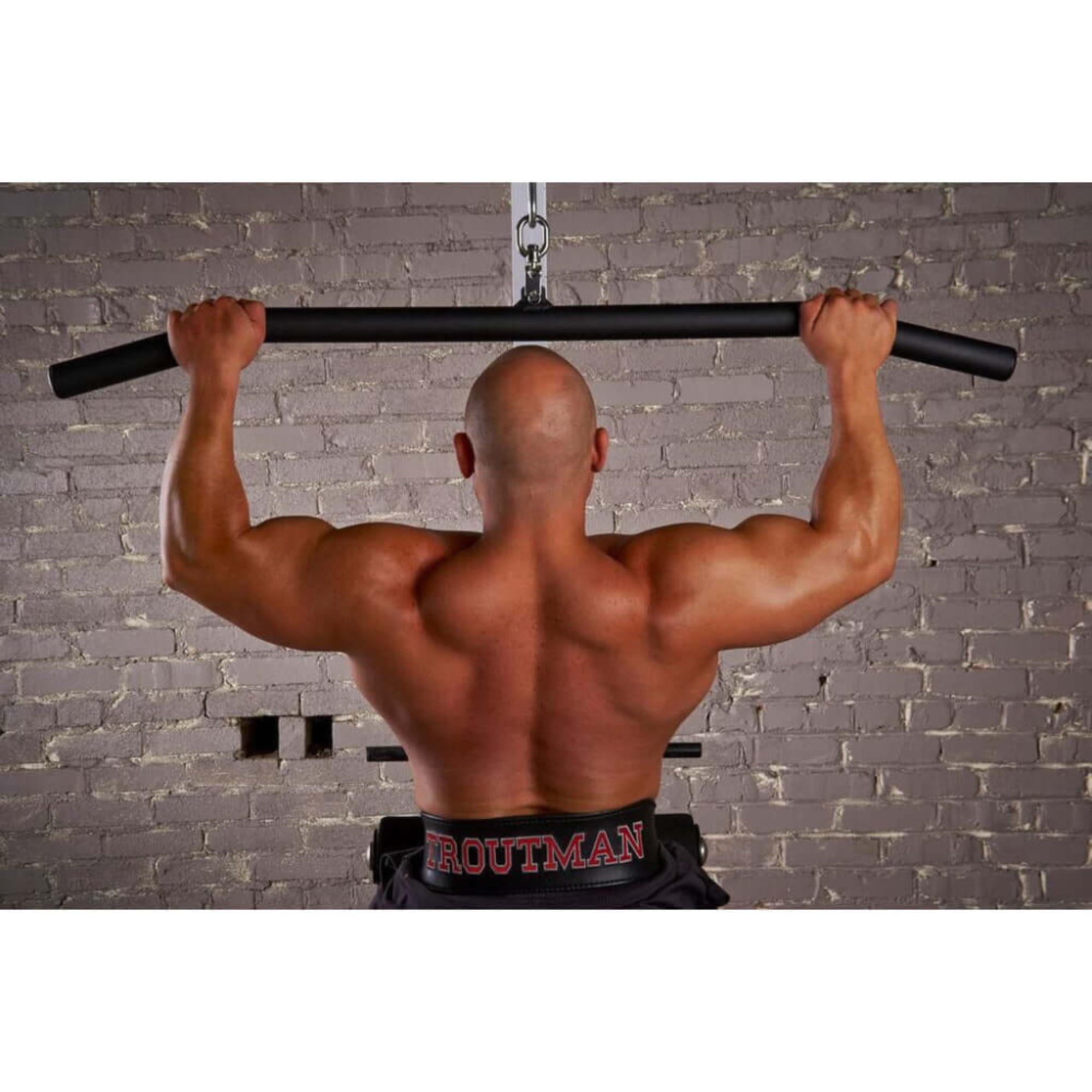 A muscular man does a pull-up showcasing back strength, rivaling any T-bar row or lat bar workout, using the HOG LEGS 'Back Pac' LEGIT Cable Machine Attachments Set.