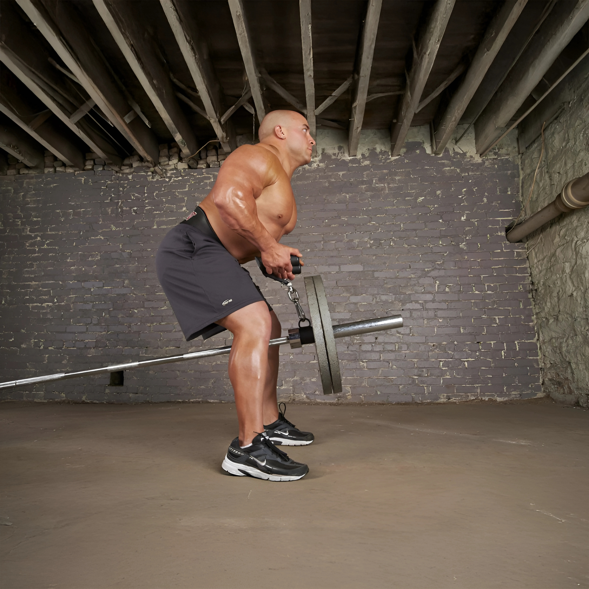 A muscular man does a bent-over row with a barbell in a basement gym, surrounded by the HOG LEGS 'Back Pac' LEGIT Cable Machine Attachments Set.