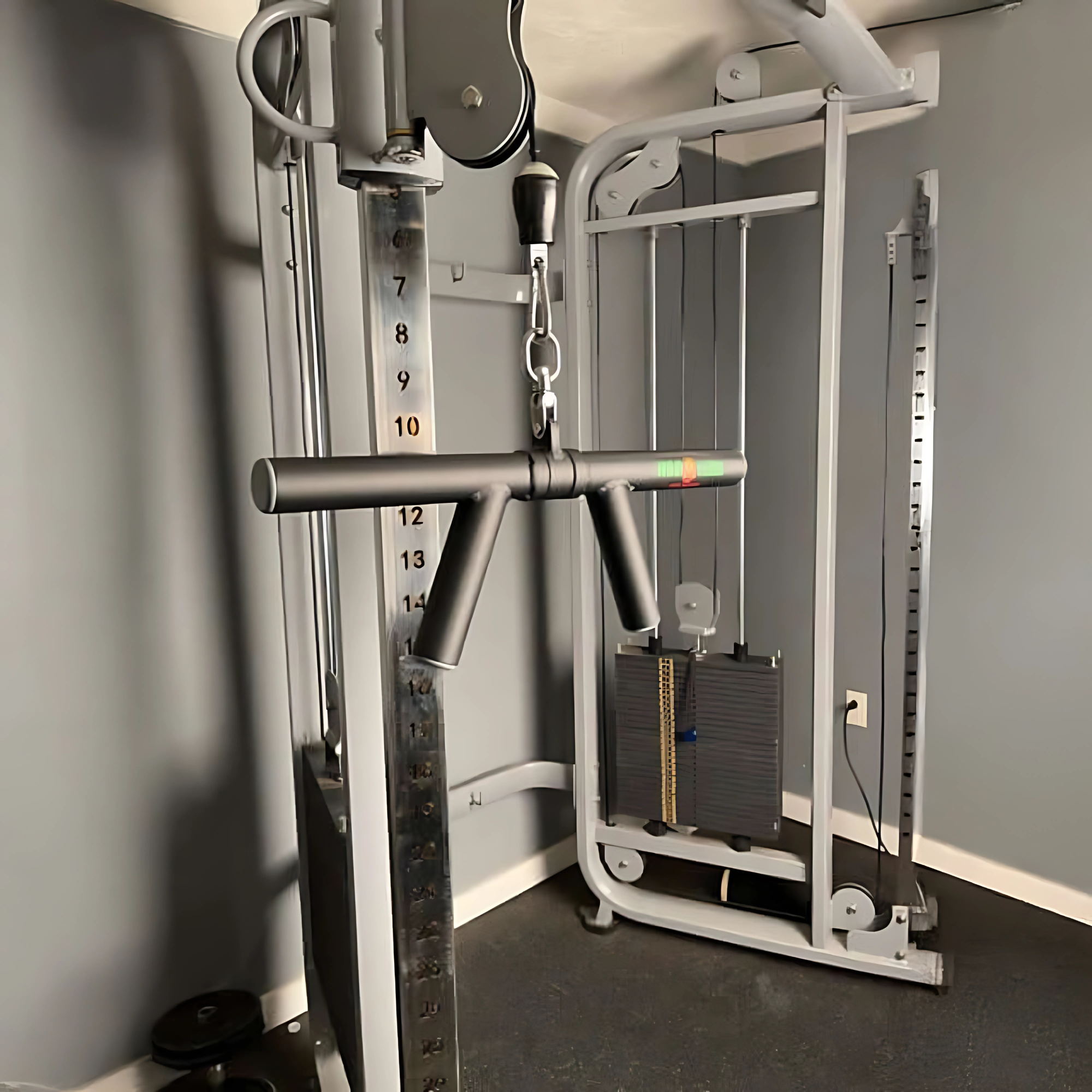 The HOG LEGS 'Boar Tusk' Fat Grip Curling Bar is perfect for triceps cable exercises in your home gym with gray walls and floors.