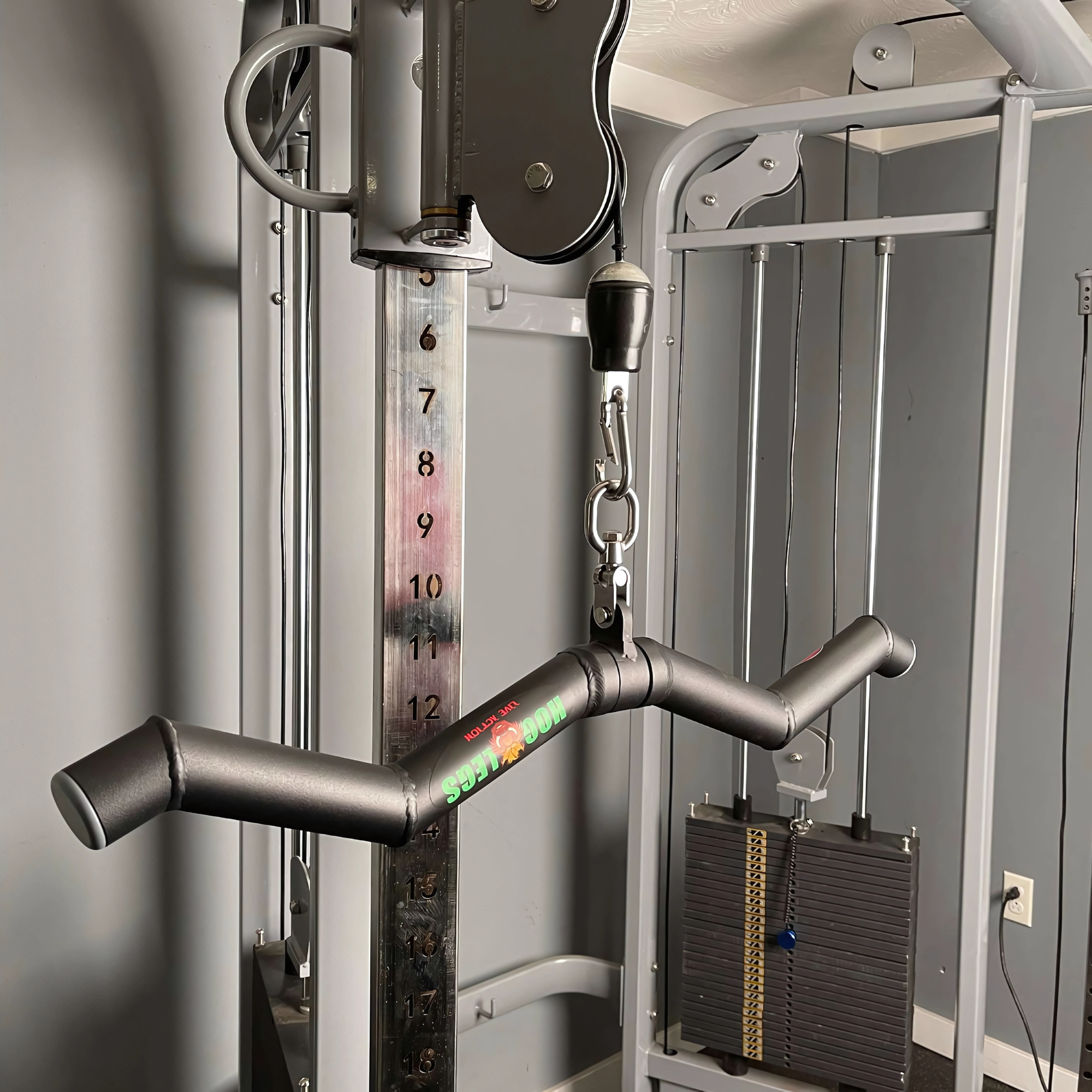 Close-up of the HOG LEGS 'Feral Hog' Arm Workouts with Cables Bar set in a home gym, engineered for toughness and covered by a lifetime warranty.