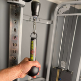 A hand gripping the HOG LEGS 'Fist Full' Pullup Handles & Tricep Attachment in a gym, boosting grip strength for effortless pull-ups.