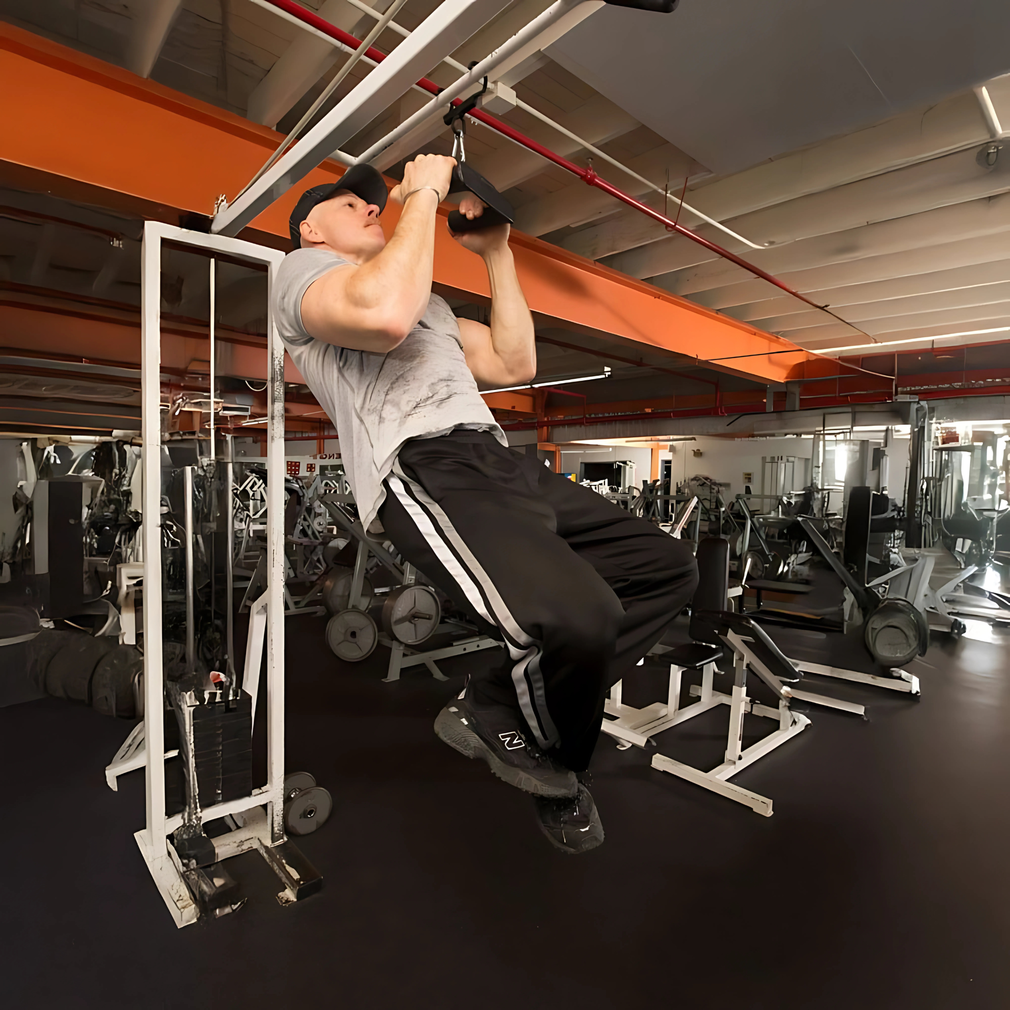 A man performs an intense upper body workout using the HOG LEGS Hog Balls Upper Body Exercise Equipment Bar in a gym with various fitness equipment in the background.