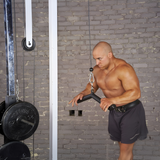 Focused shirtless man grips the HOG LEGS 'Hog Wild' Workout Cable Attachments gone Fat! in the gym, maximizing muscle stimulation during his routine.