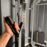 A person at the gym uses a pull-down cable machine with HOG LEGS 'Jawbone' FAT Back Cable Workout Handles for improved strength and comfort.
