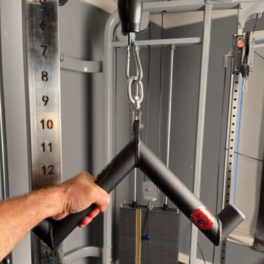 A person uses the HOG LEGS 'Pork Chop' Killer Triceps Workout Cable Bar at the gym to execute precise Triceps Extensions.