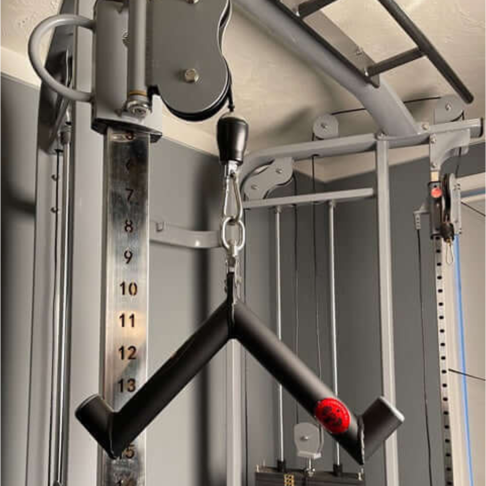 Close-up of the HOG LEGS 'Pork Chop' Killer Triceps Workout Cable Bar with V-shaped handle and weight selector, ideal for triceps extensions and cable press downs.