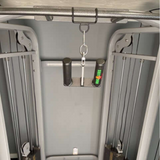 Close-up of a cable machine with HOG LEGS Pull Up Hooks, featuring patented hook technology, and a small can of WD-40.