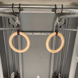 Two HOG LEGS Pull Up Hooks for Exercise Cable Attachments hang from straps on a metal gym machine.