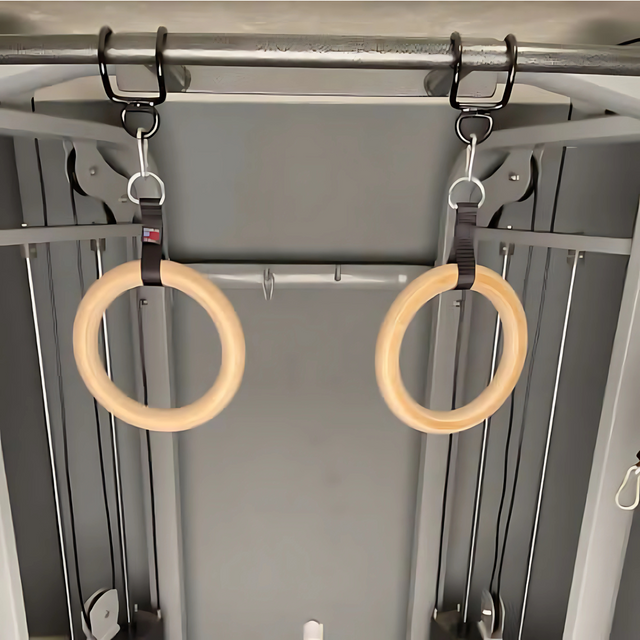 Two HOG LEGS Pull Up Hooks for Exercise Cable Attachments hang from straps on a metal gym machine.