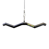The curved, black HOG LEGS 'SubPrimal' EZ Curl Bar, designed for muscle stimulation and featuring the "Dog Legs" logo, hangs from a cable.