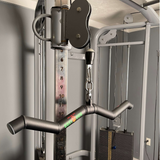 Close-up of a gym cable machine with the HOG LEGS 'SubPrimal' EZ Curl Bar / Triceps Workout Bar attachment and weight stack, designed for ultimate muscle stimulation.