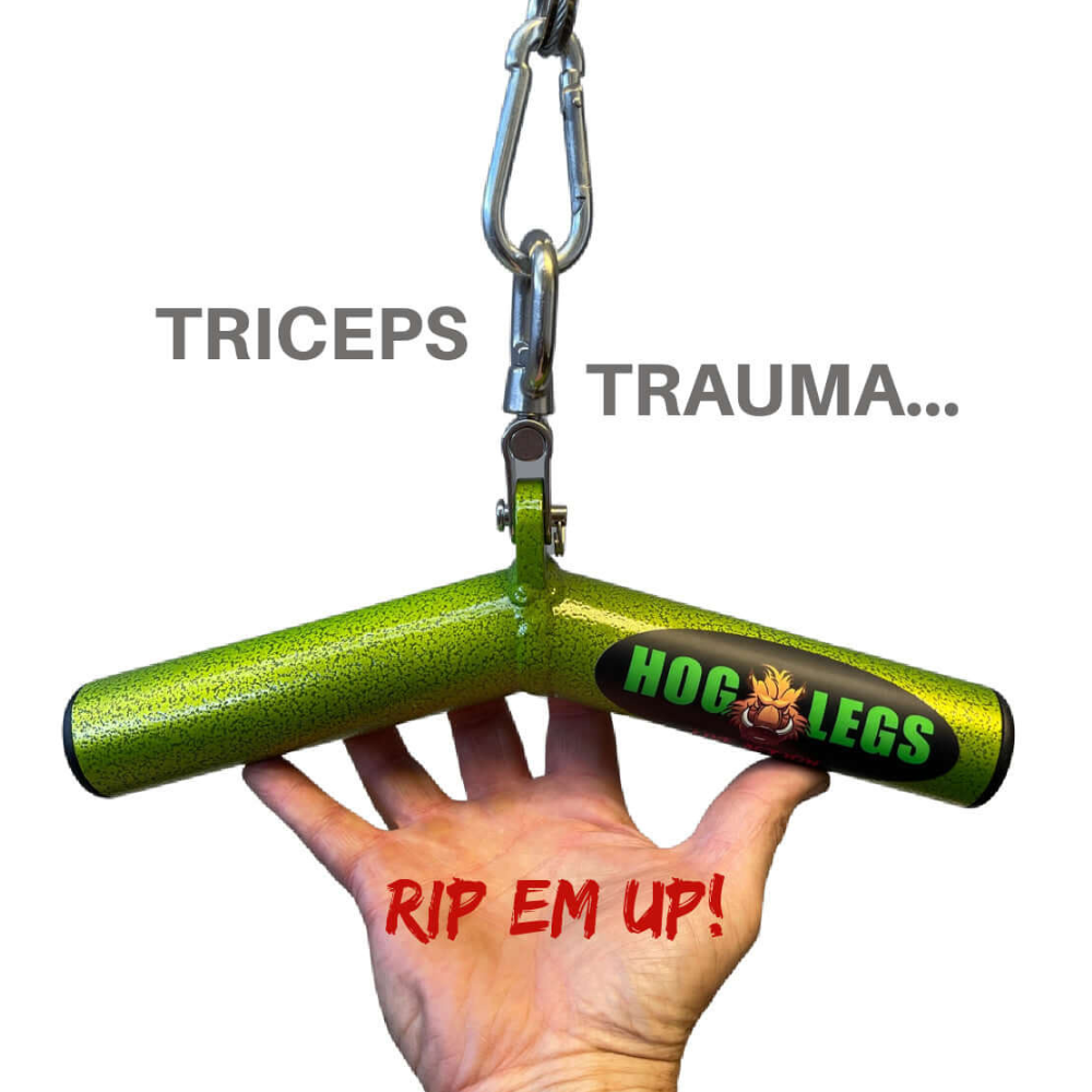 A hand grips a commercial-grade, green T-shaped gym attachment labeled "HOG LEGS Wicked 'Piglet' Tricep Bar Workout gone FAT!" designed for focused triceps targeting and intense muscle stimulation. The text reads "TRICEPS TRAUMA... RIP EM UP!.