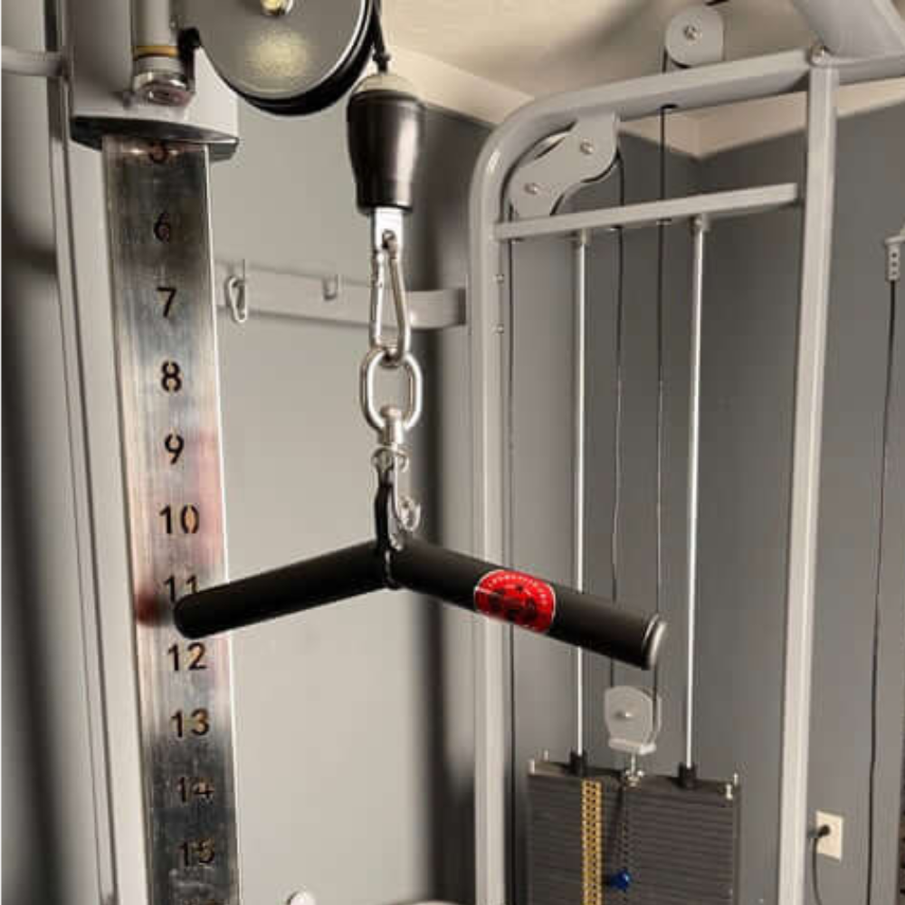 Close-up of a gym cable machine featuring the HOG LEGS Wicked 'Piglet' Tricep Bar with T-bar handle and weight stack, crafted for optimal triceps targeting in a fitness room.