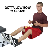 Man exercising with resistance bands and the PULL FORCE GEN 2 Double Grips Cable Gym Attachment while seated on the floor, feet braced against a bench.