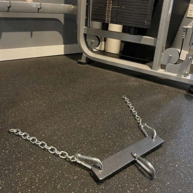 Close-up of a commercial-grade gym floor featuring a rowing machine chain and footrests, highlighting the PULL FORCE MULTIPLIER of Gym Cable Machine Weight Stacks in action.