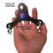 A hand grips a black, triangular steel plate with rings and a handle attachment, featuring a blue "Made in USA" label, designed for Dual Cable machines; it's the PULL FORCE Mini Multiplier Home Gym Cable Machine Yoke.