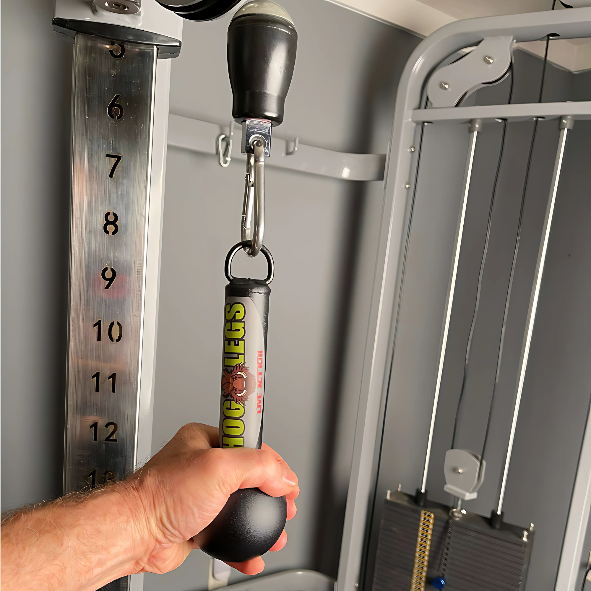 Close-up of a hand gripping a PULL UP BAR WORKOUT 'Extreme pack' by LPGmuscle, a commercial-grade attachment on gym exercise equipment.