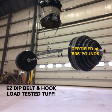 A barbell hangs from the Patented DIPPING BELT HOOK for Dip Belt with Chain in a warehouse, labeled "CERTIFIED at '505' POUNDS.