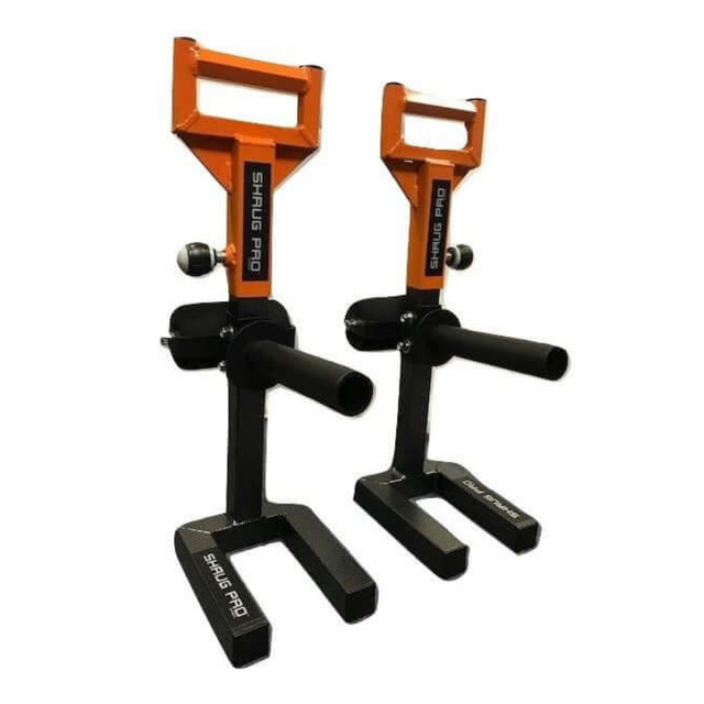 Two orange and black gym handles with support stands labeled "SHRUG PRO," resembling a sleek farmers walk platform, are actually 'SHRUG PRO' Freestanding Hex Bars, serving as an alternative to the Trap Bar Barbell Shrug.