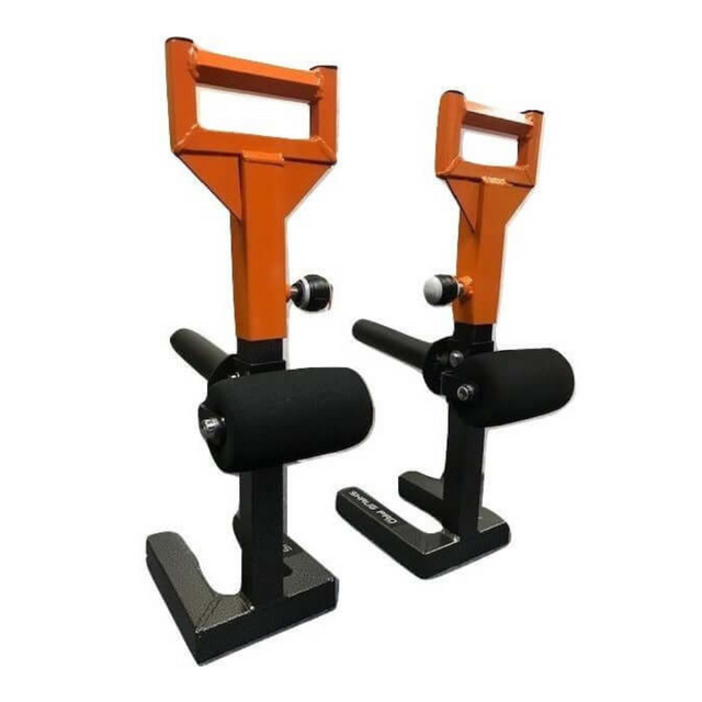 Two orange, adjustable Nordic hamstring curl devices on a white background designed to integrate effortlessly with equipment like the 'SHRUG PRO' Freestanding Hex Bars.