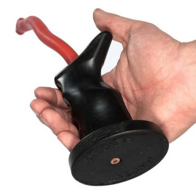 A hand grips the TACTI - TRICEPS 'Single' Tricep Attachment, an ergonomic tool with a black and red curved handle and round base, ideal for triceps workouts on a cable machine.