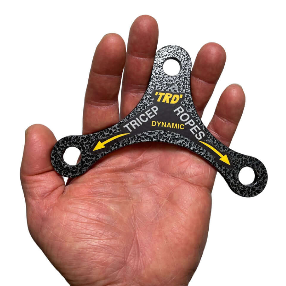 A hand grips a black, triangular TRD 'Dynamic Action' Yoke Triceps Attachment Gym Handle with two holes and arrows—showcasing the precision of PULL FORCE handles, ideal for any Cable Machine Attachments setup.