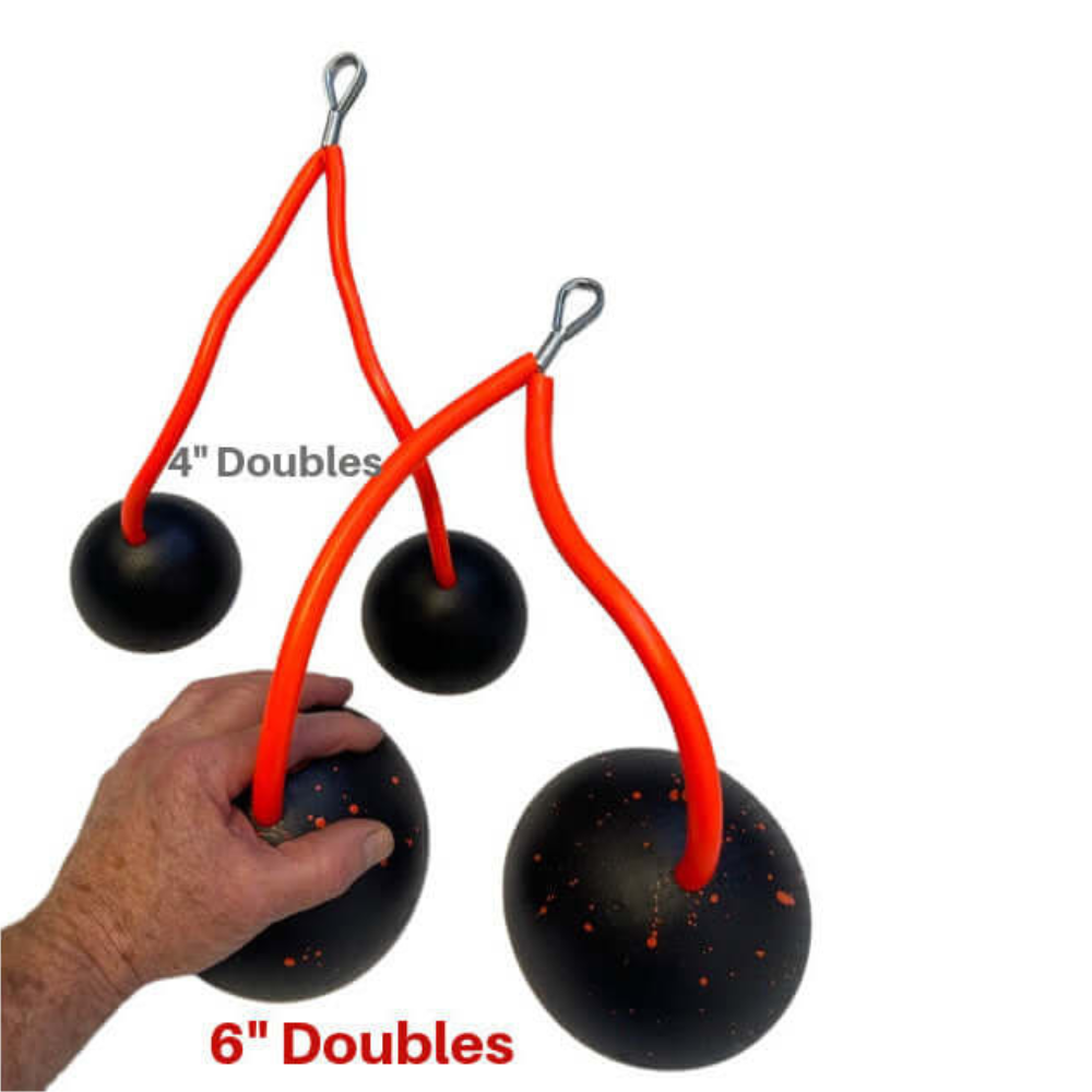 A hand holds 6-inch juggling balls with orange strings next to smaller 4-inch doubles, resembling TRIBELLS 4" 'Double' Tricep Workout with Cables Gym Handles in motion.
