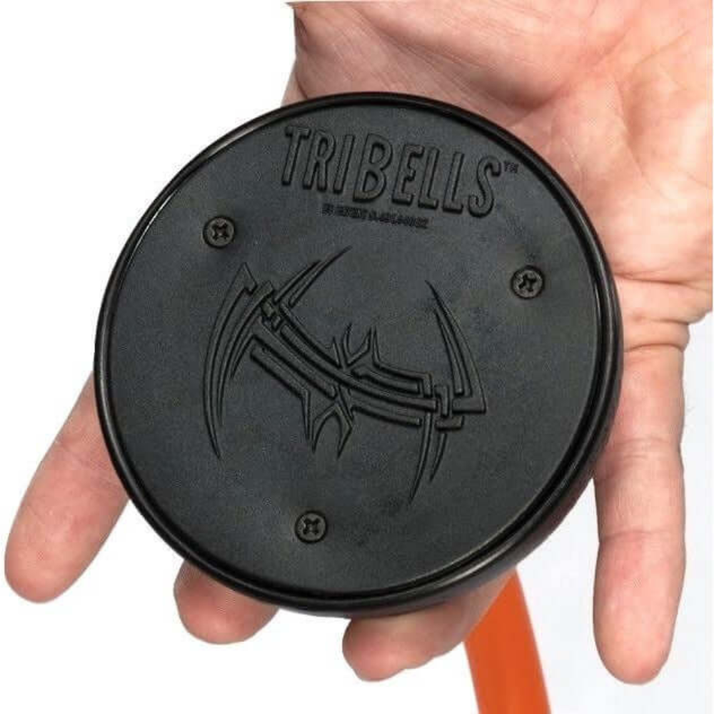 A hand grips a round black TRIBELLS 4" 'Double' Tricep Workout object, featuring an embossed design and screws, seamlessly paired with an orange handle ideal for triceps cables.