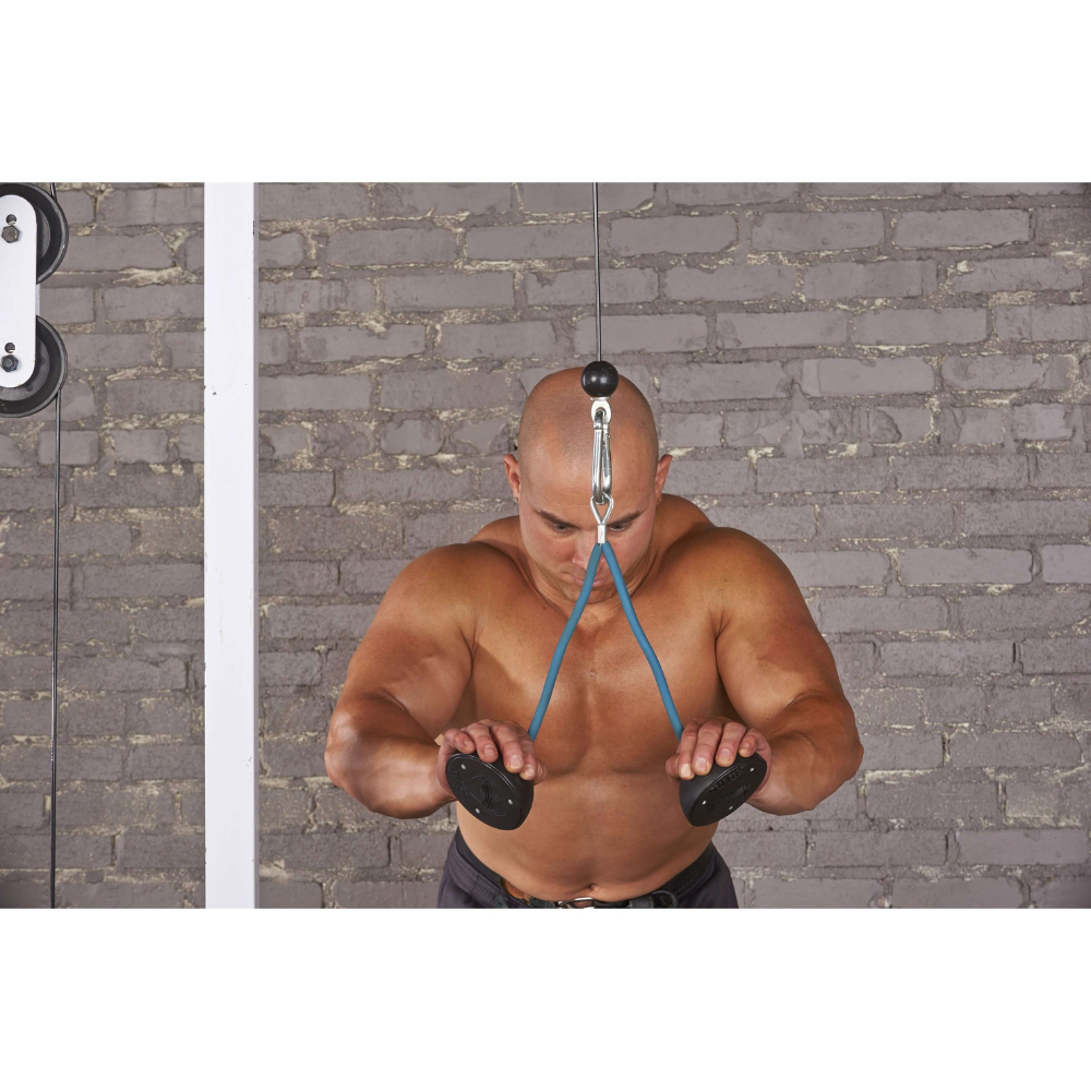 A bald man intensely uses the TRIBELLS 4" 'Double' Tricep Workout with Cables Gym Handles on a cable machine in the gym, set against an industrial brick wall backdrop.