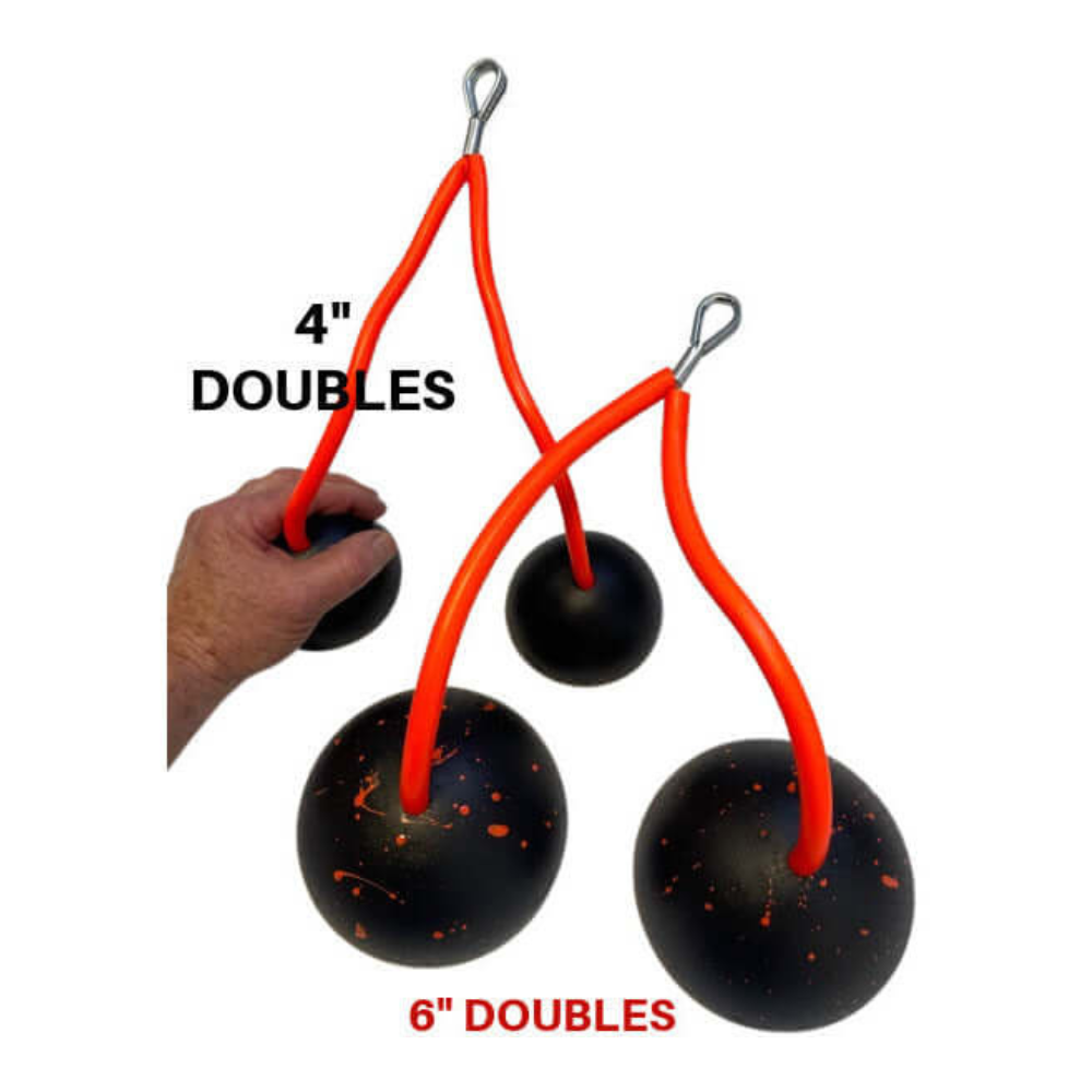 Black spheres with orange speckles connected by cords resemble TRIBELLS, labeled 4" Doubles. Ideal for enhancing workouts, these TRIBELLS 4" 'Double' Tricep Workout with Cables offer unique triceps strengthening while their gripping domes ensure stability.