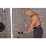 A shirtless man enhances his tricep workout at the gym, sweating while using the TRIBELLS 4" 'Hi-Tech' Cable Tricep Attachment Tricep Rope.