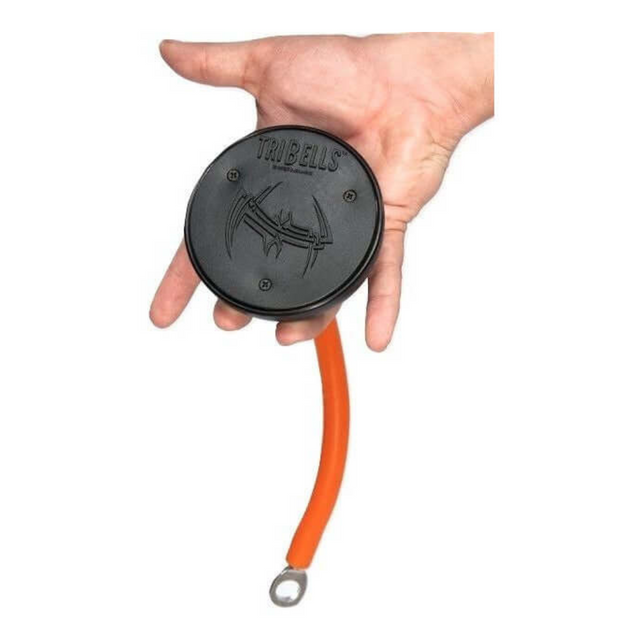 A hand grips a TRIBELLS 4" 'Hi-Tech' Cable Tricep Attachment, featuring a round black design similar to tricep ropes, with an orange flexible tail and a circular metal loop at the end.