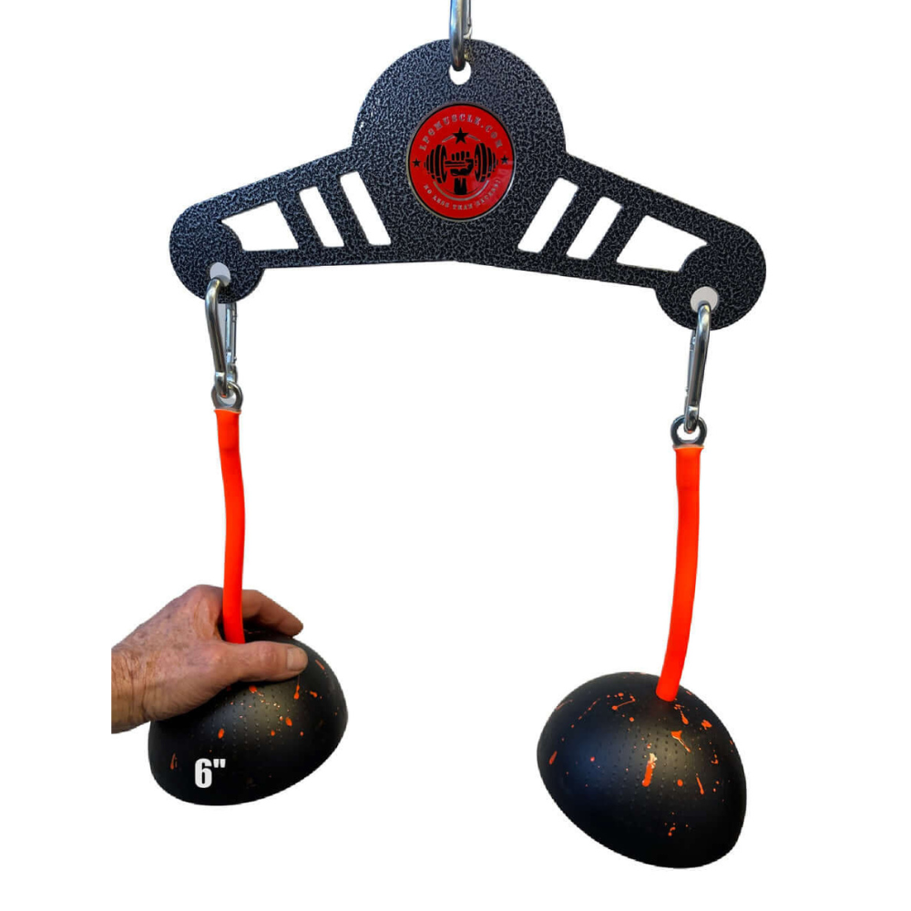A person holding the TRIBELLS 'Double Wide' workout with orange cords and black half-spheres, ideal for triceps extensions, neatly hanging on a metal hanger.