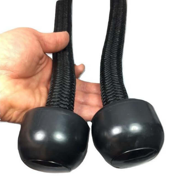 A hand holds two TRICEPS ROPE EXTREME 'Singles', featuring black flexible braided loops with cushioned grips and large rounded ends, ideal for enhancing your exercise routines.