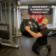 Man kneeling in gym, slamming large black ball with text: "PHYSIO TWIST Swiss Ball Handle Straps for Cable Machine Core—build explosive core power and torque fast!.
